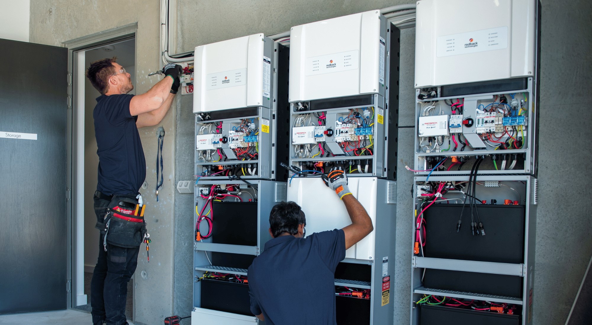 Three solar batteries being installed at commercial property. 