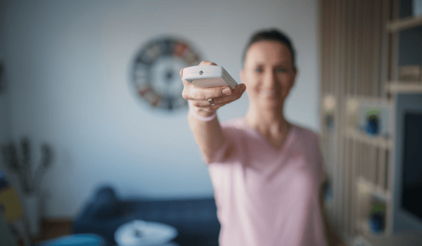 Lady turning off the A/C in her home