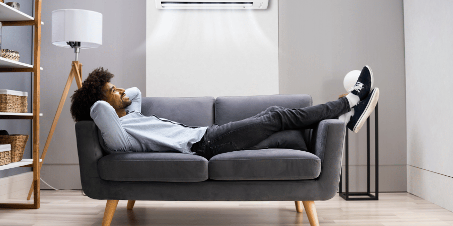 Man on couch with A/C on