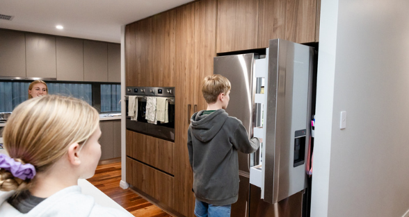 Family looking in a fridge