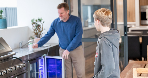 Plico member with son in outdoor kitchen