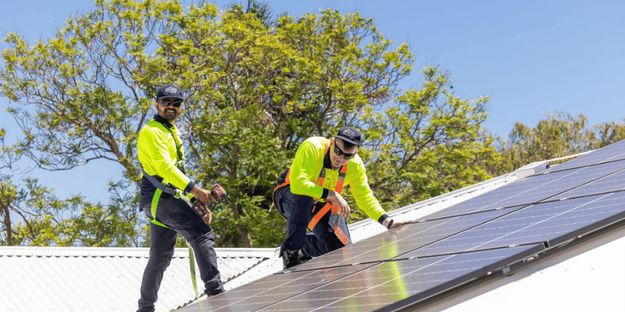 People on roof installing solar panels 