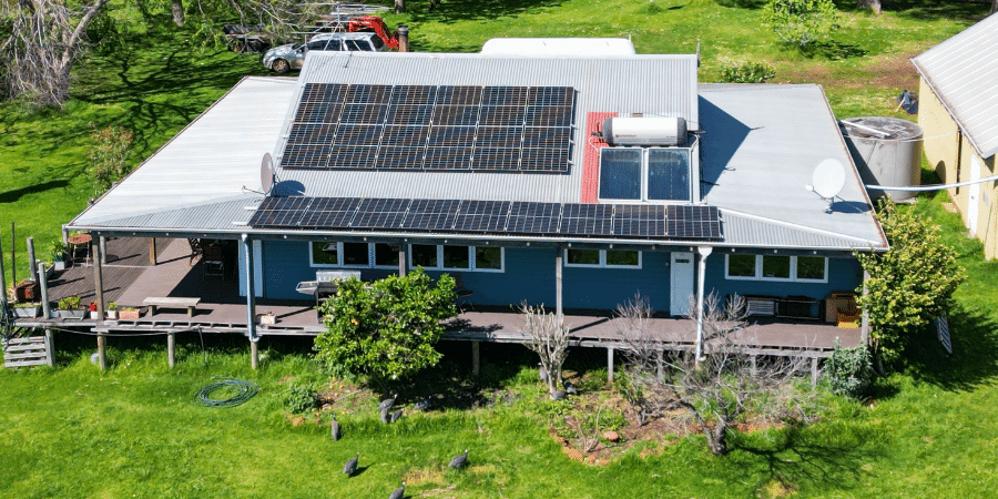 Large home in country setting with solar panels on roof