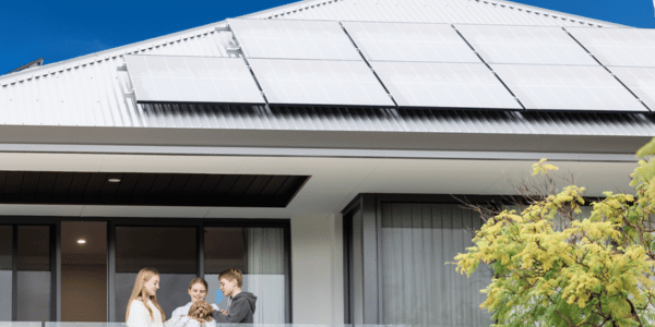 House with solar panels and children on balcony