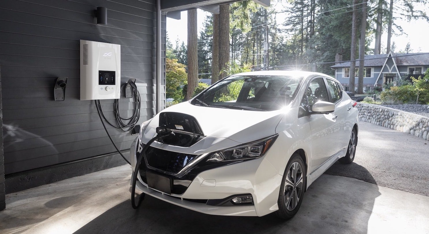 Image of an electric vehicle being charge at a house with a level 2 EV charger.