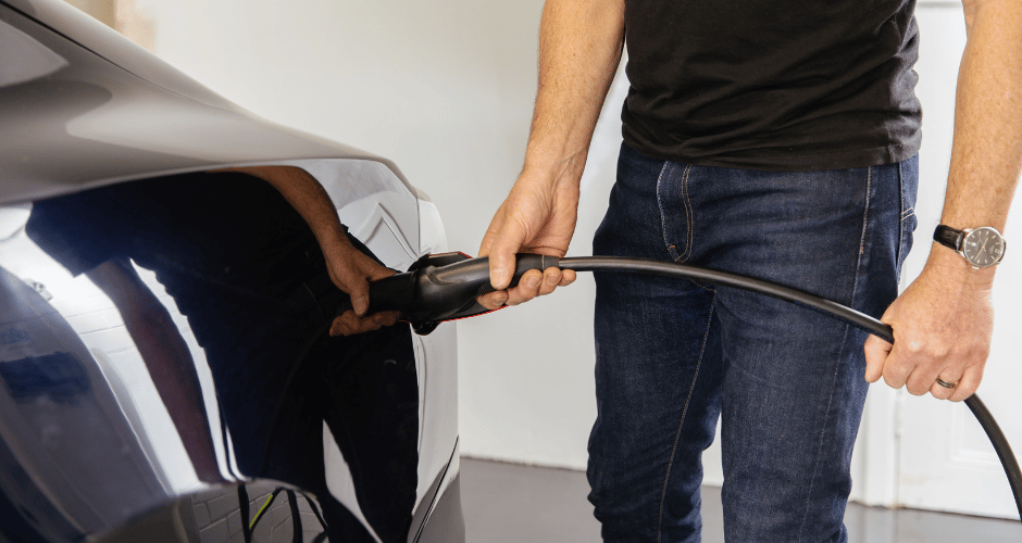Man charging an electric vehicle