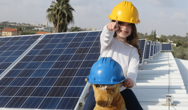 Girl with a hard hat on a roof with solar panels