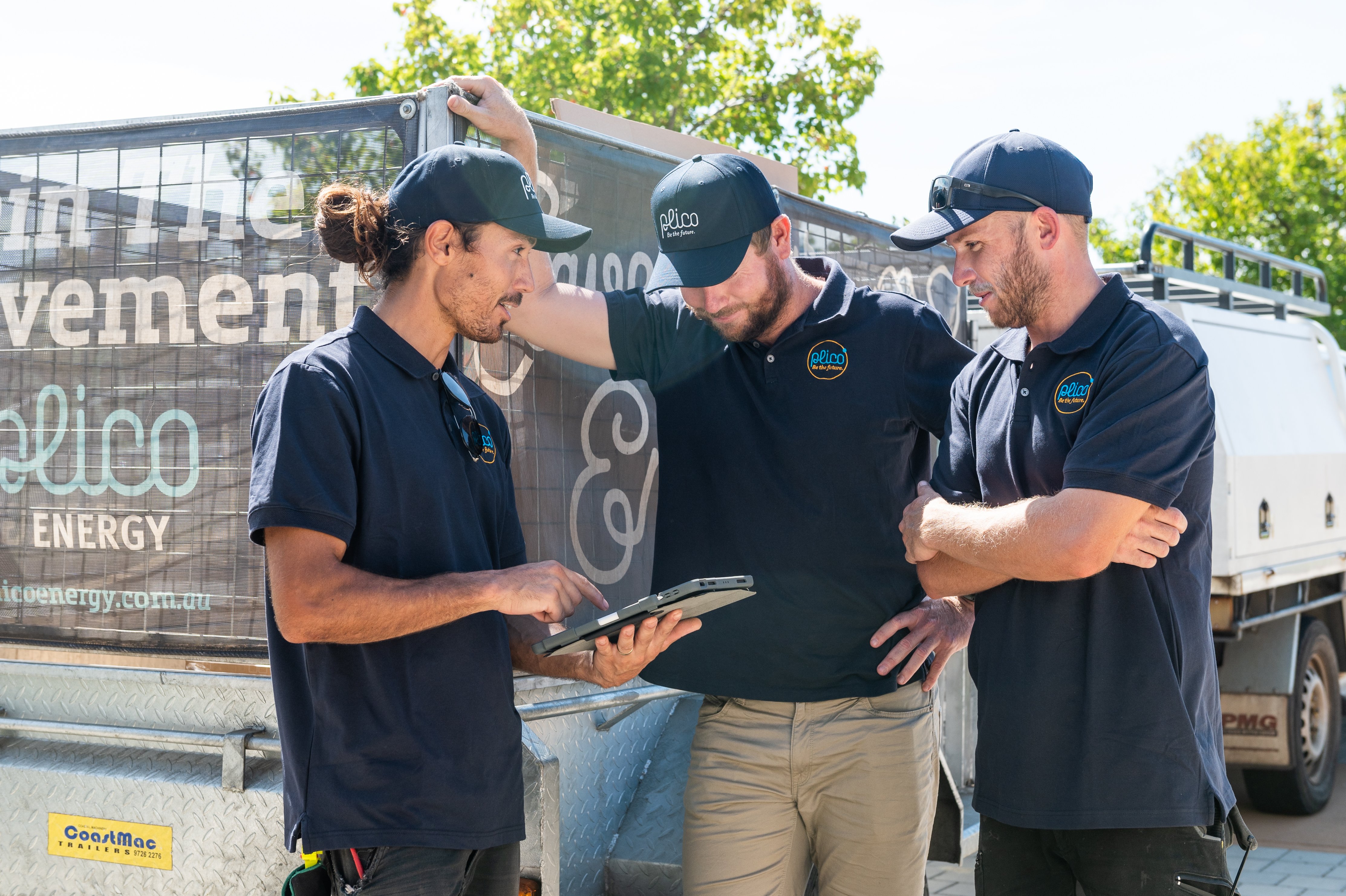 Image of three Plico workers discussing the details of installing a residential solar + battery system.