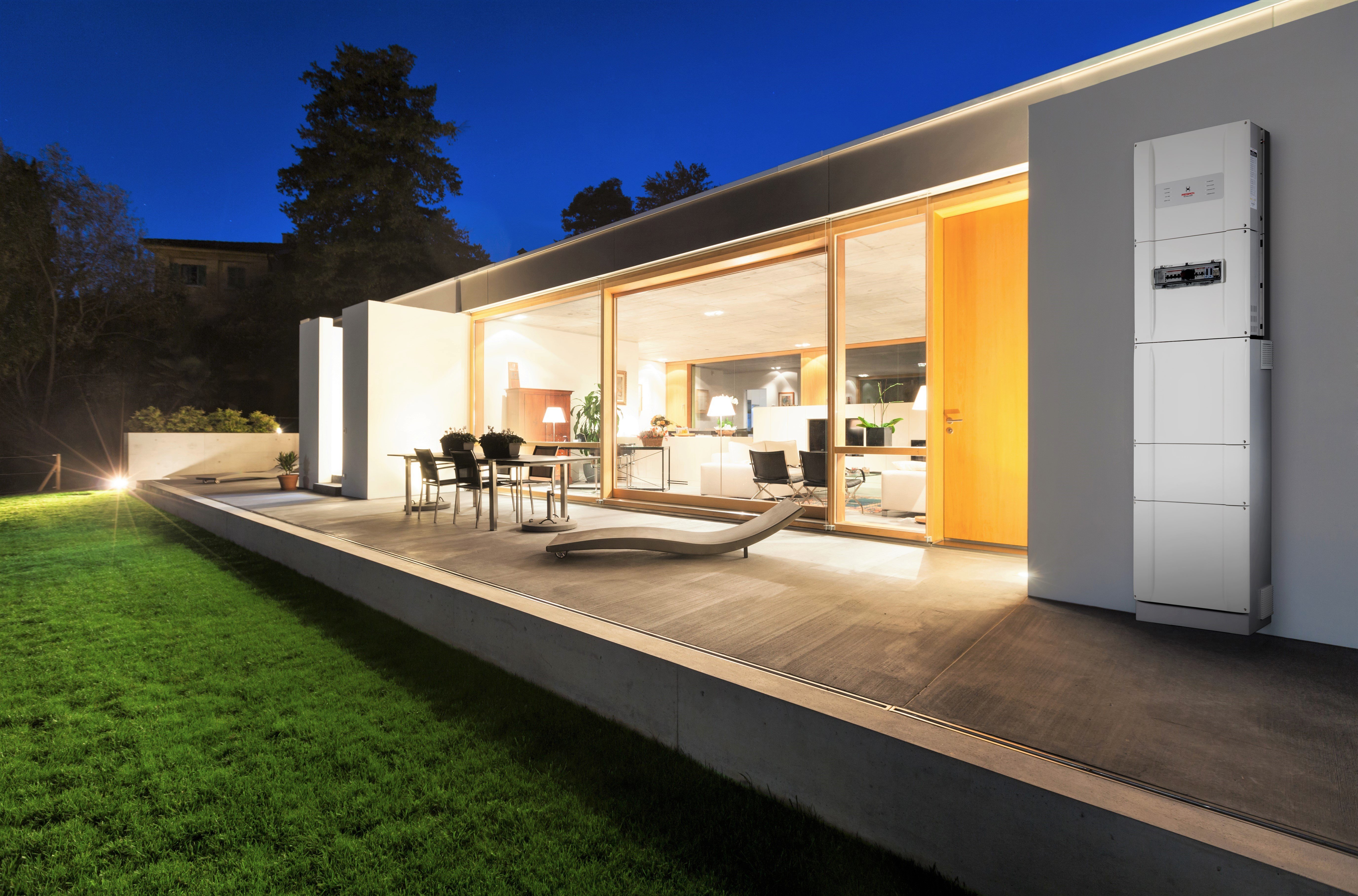 redback inverters on white house at night with a lawn in the foreground