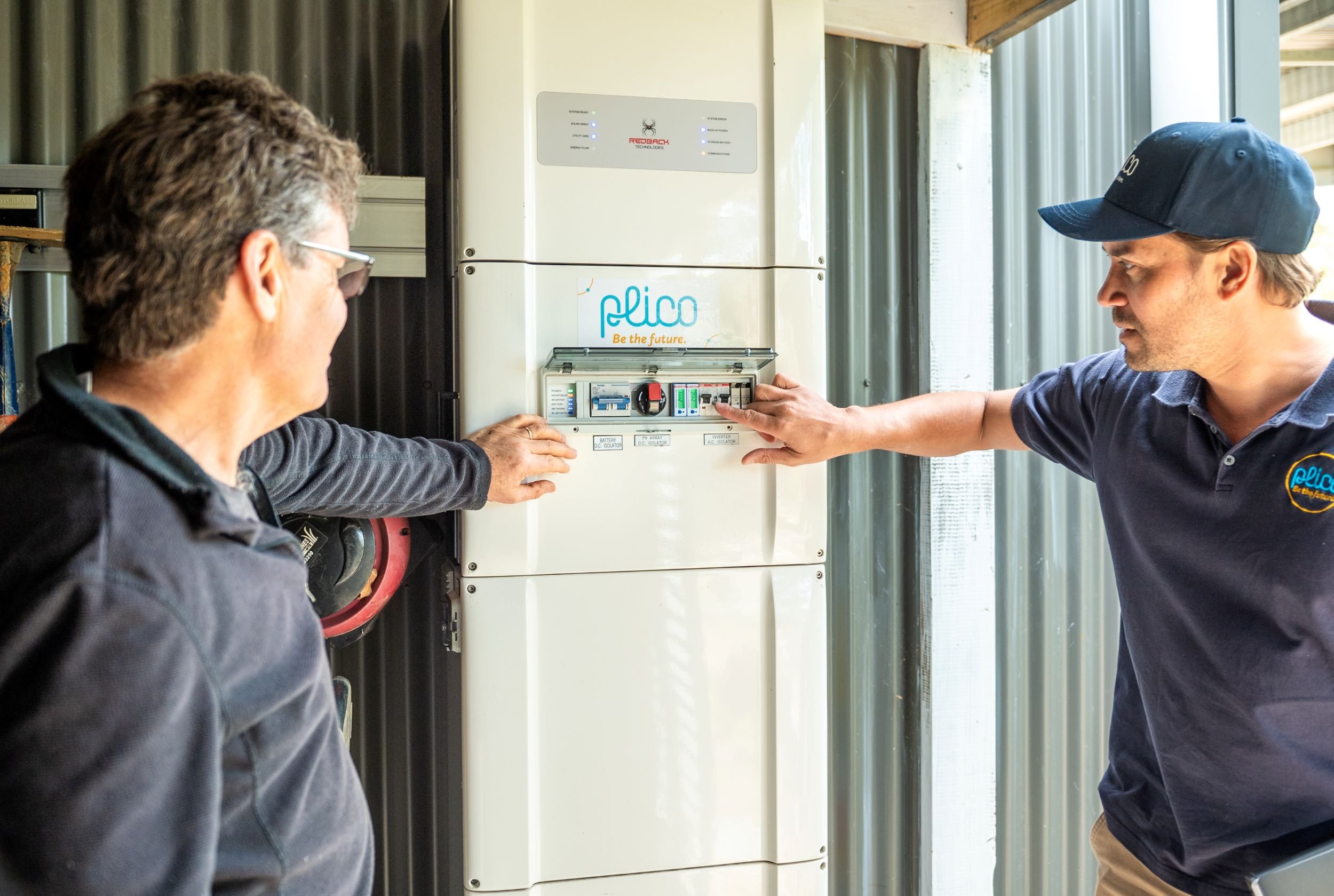 Plico team member showing customer how to use their solar battery