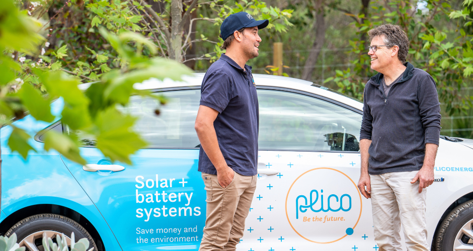Plico team member with customer talking in front of car