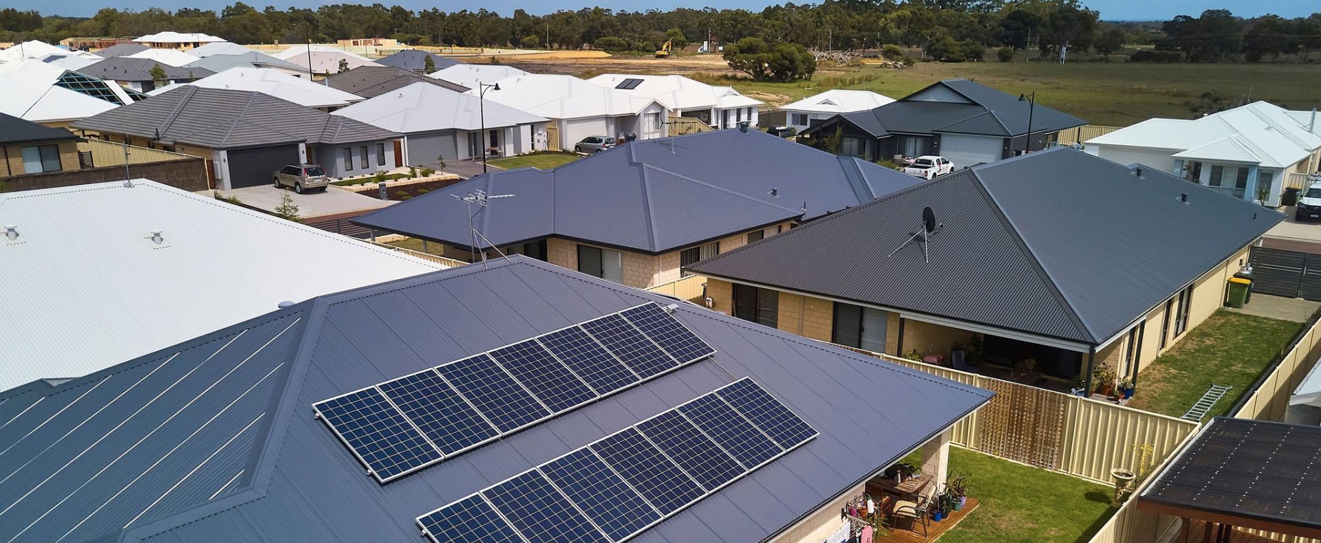 neighbourhood houses with solar panels on their roofs
