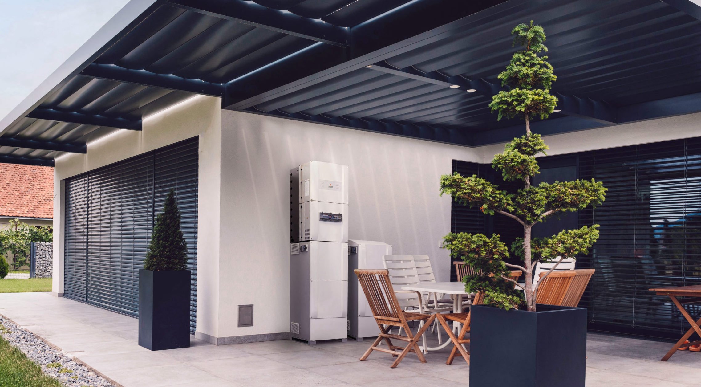Image of Redback Smart Hybrid Solar Inverter installed outside a suburban home.