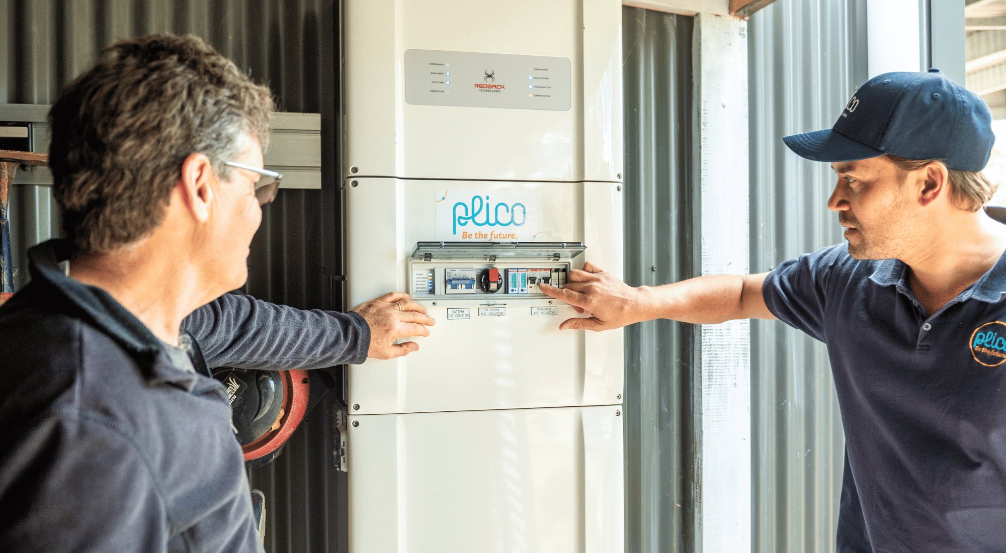 Plico team member showing customer how to work their solar battery. Plico team member showing customer how to work their solar battery.