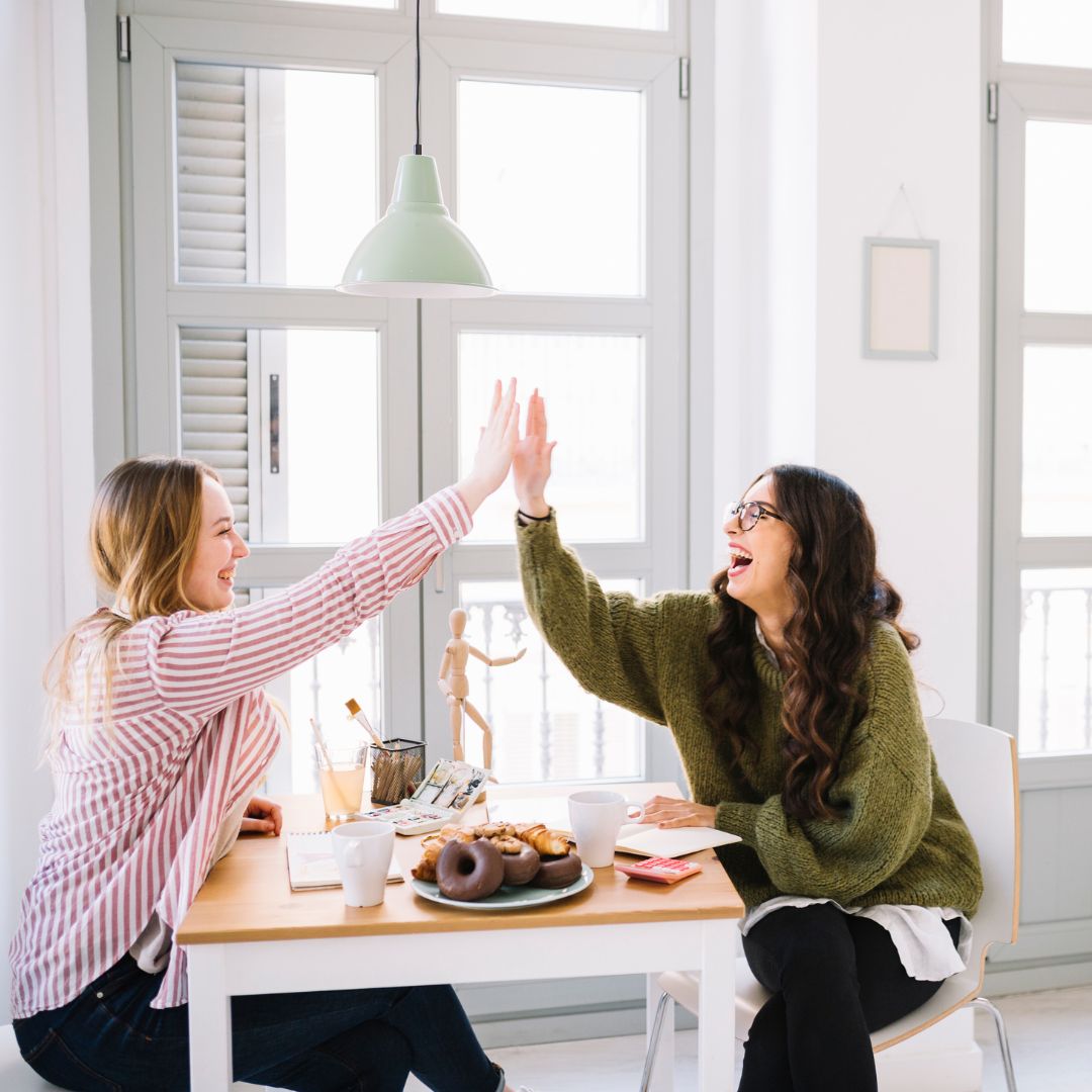 two people high fiving 